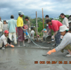 Levelling and vibrating the concrete mixture for the top of the ground floor
